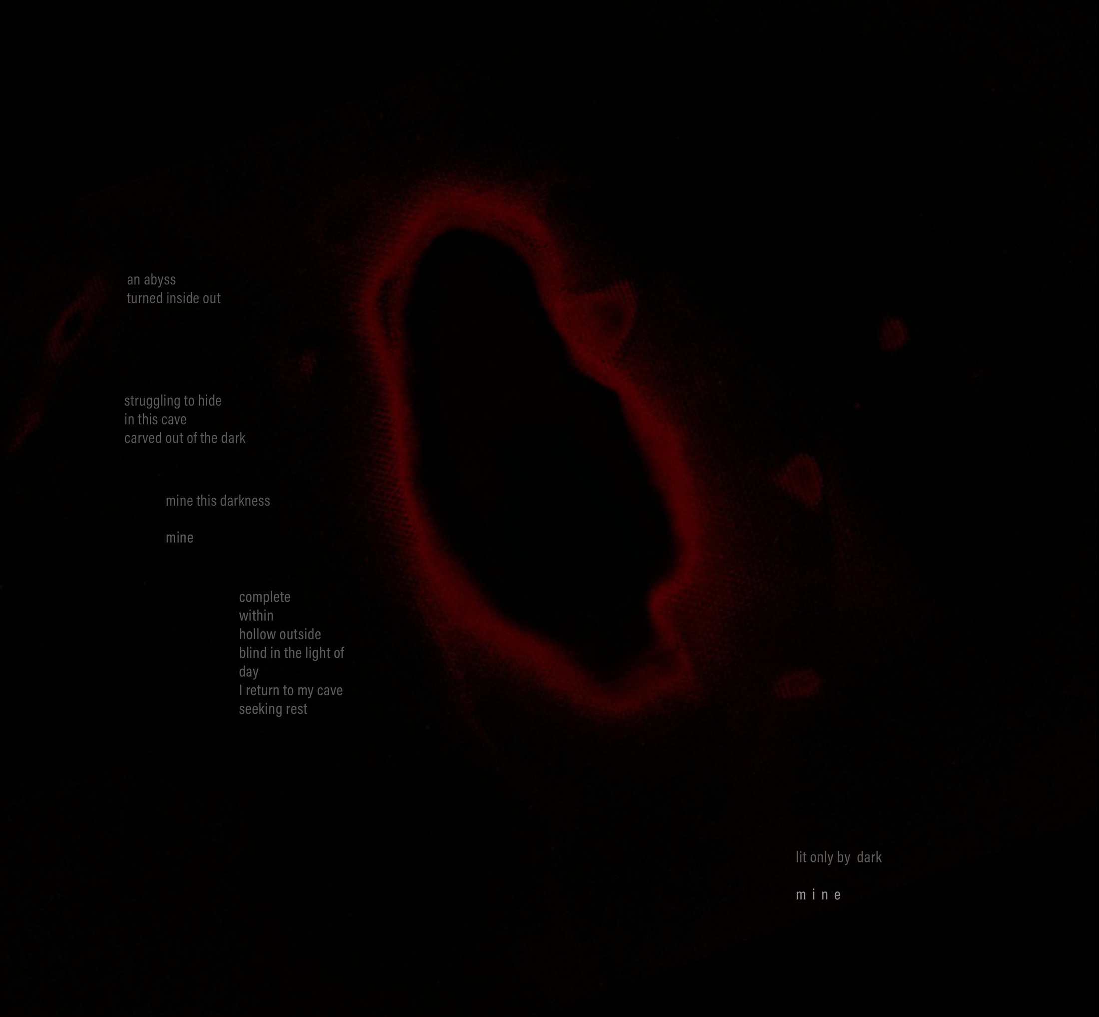 A red ring glowing out of a black page, a poem set faintly within the dark