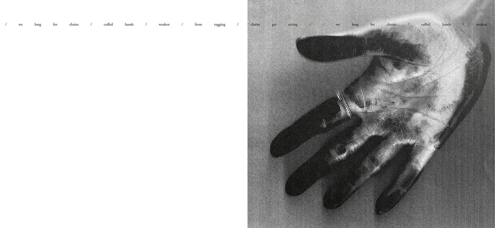 A hand open on grainy ground, a line of spaced words running above it across both pages